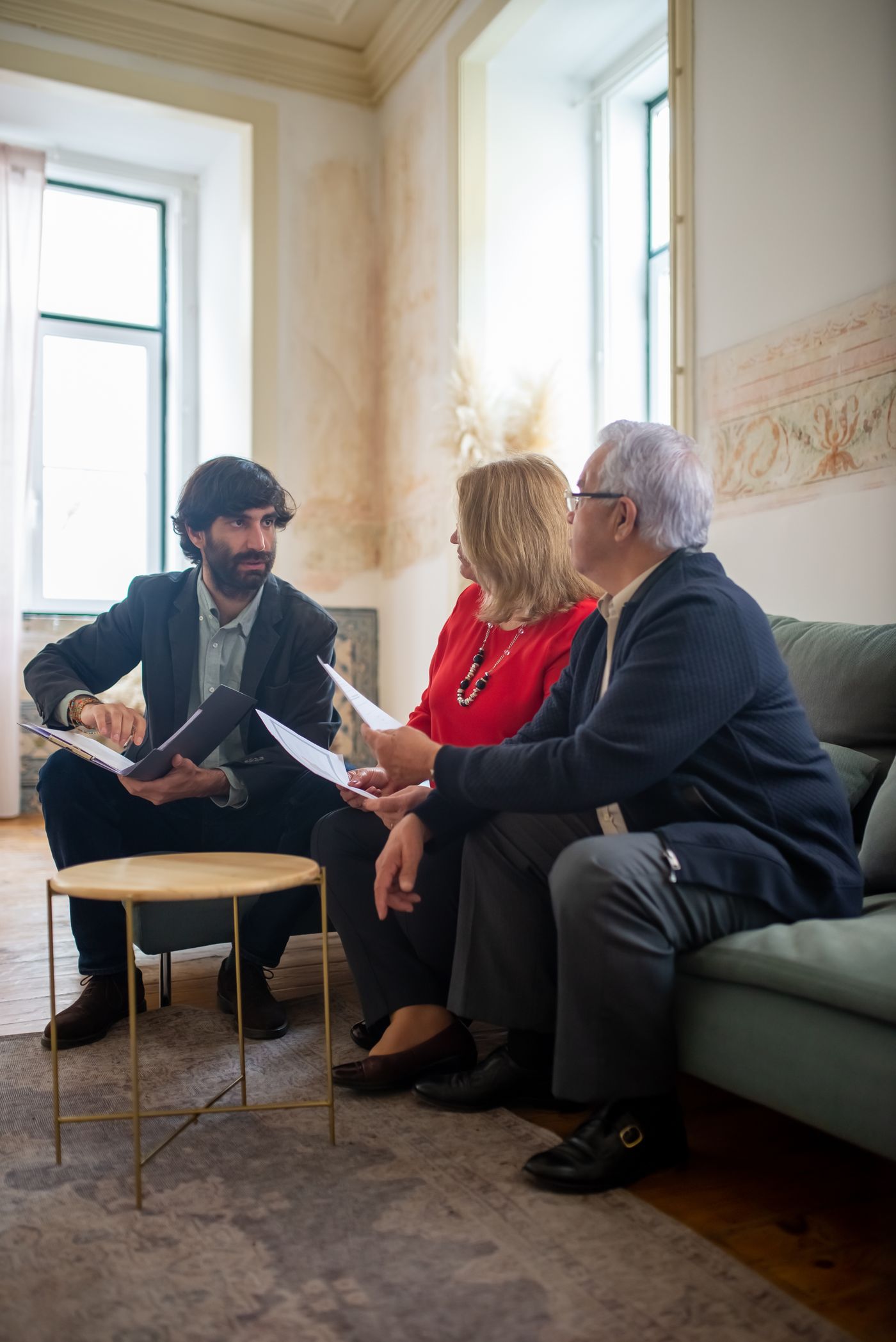 Verified representative discussing gold valuation with a customer at home