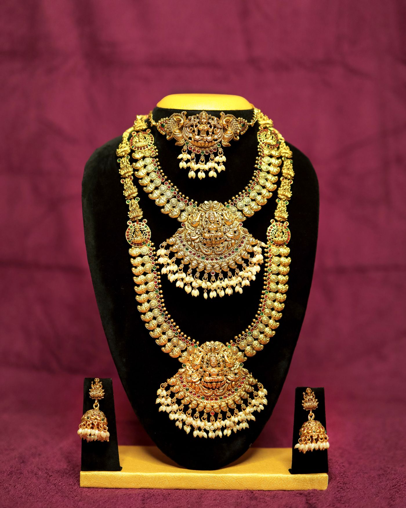 Elegant gold jewellery set displayed on velvet