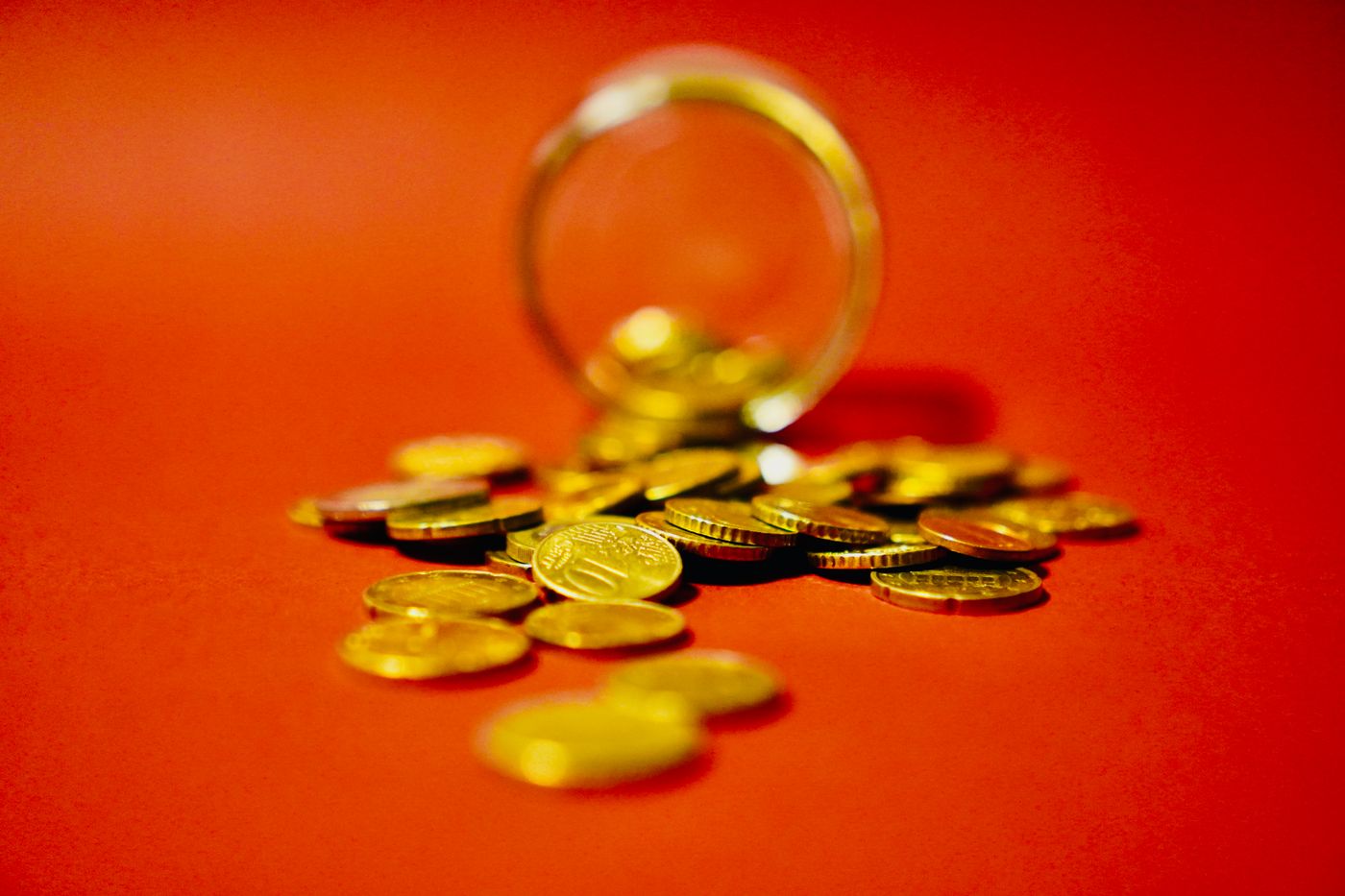Gold coins spilling from a jar, representing sell and save options